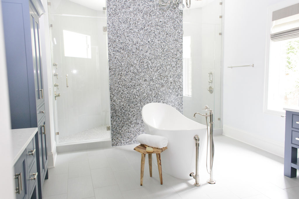 after TEW design redesigned their bathroom with bright vibrant whites and stand alone tub in middle of the room