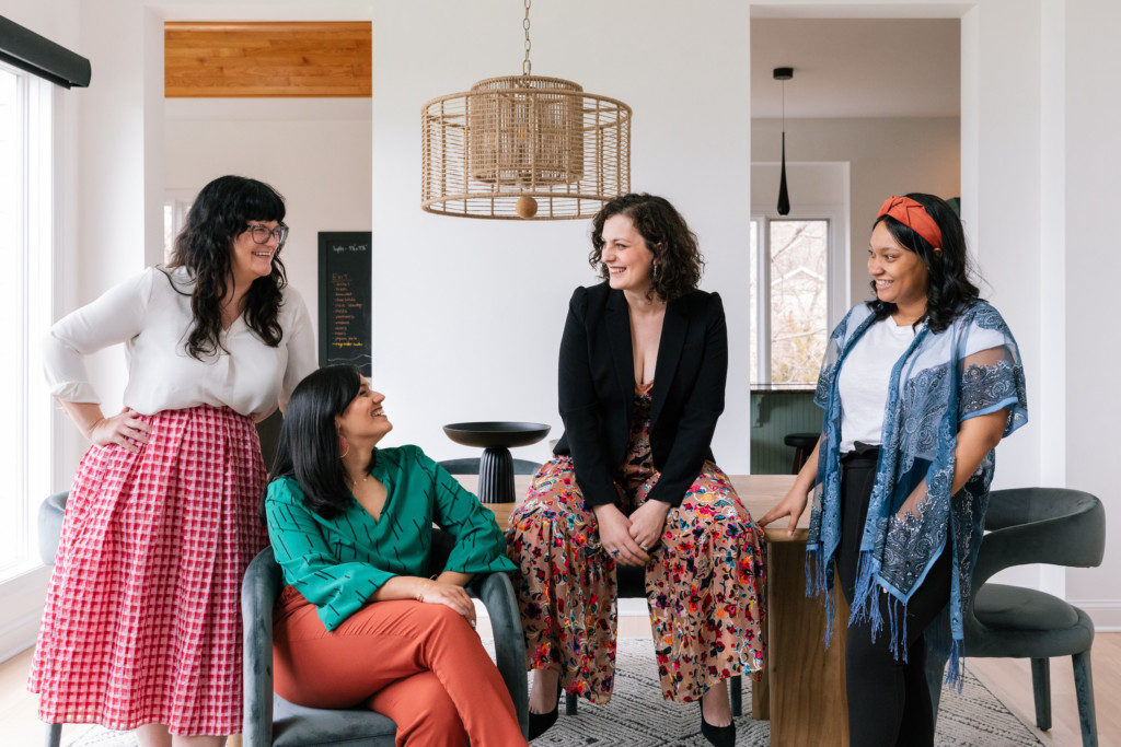 The interior design team in Apex featuring four women sitting and standing side by side. 