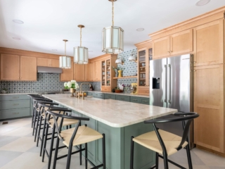 TEW DESIGN STUDIO | HEATHER RIDGE KITCHEN Diagonal view of kitchen showcasing light fixtures, brass hardware, natural textures and earth tones.
