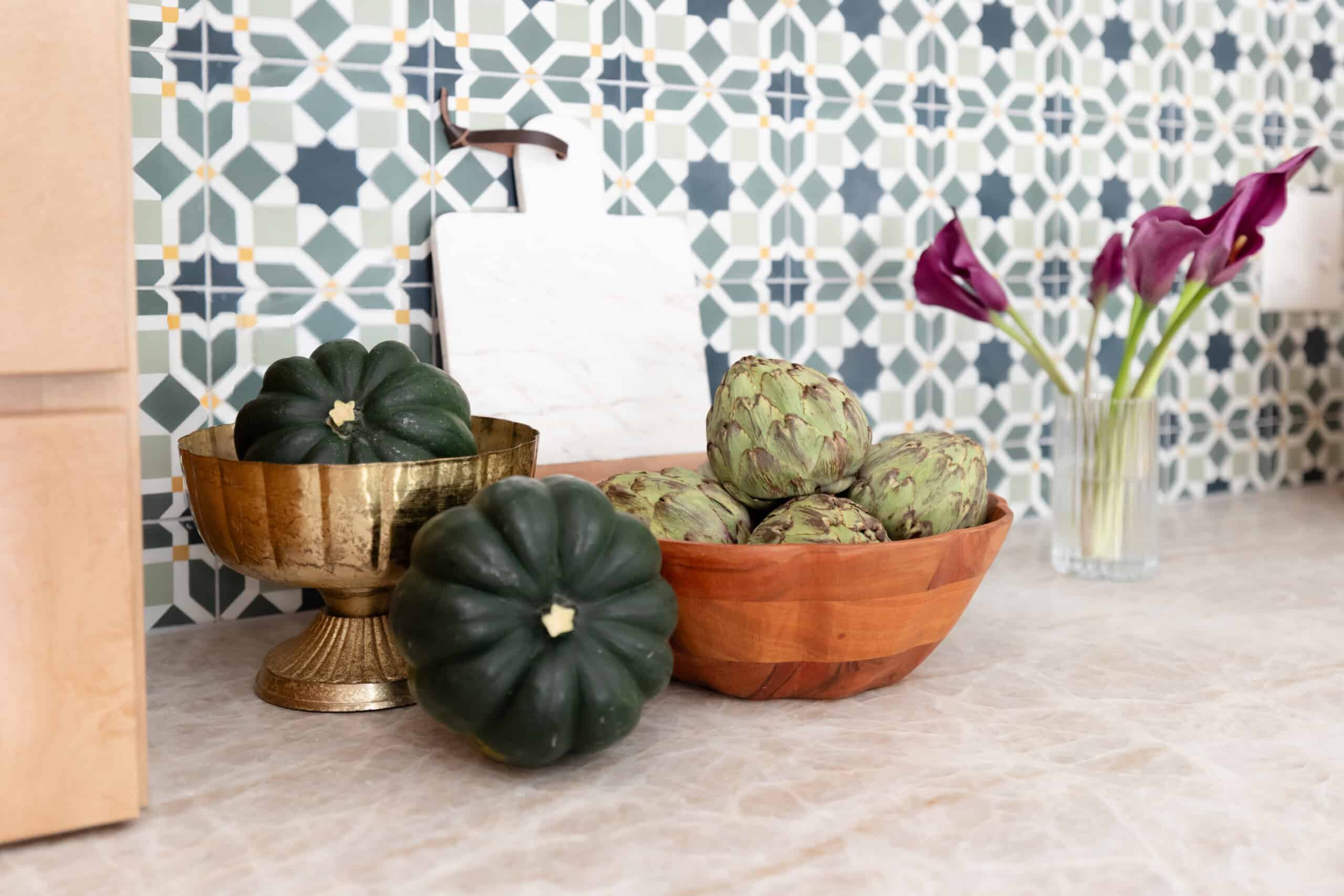 Close view of kitchen marble and textured wall tile showcasing decor options.