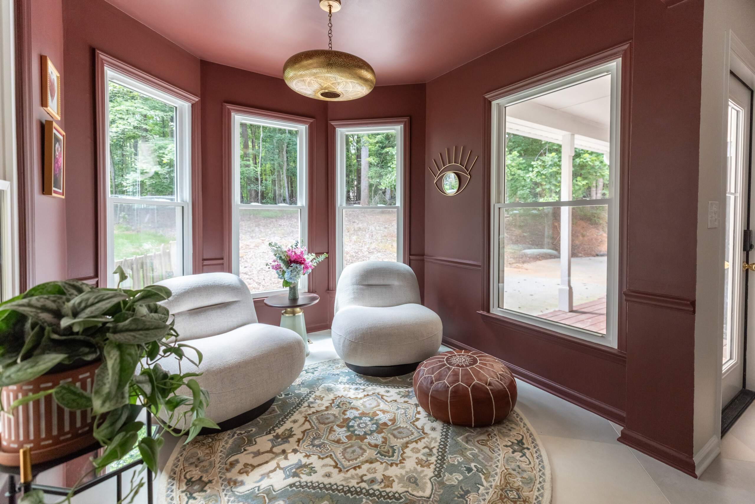 Cozy breakfast nook turned sitting area with bold, earthy tones providing functionality and cohesion.