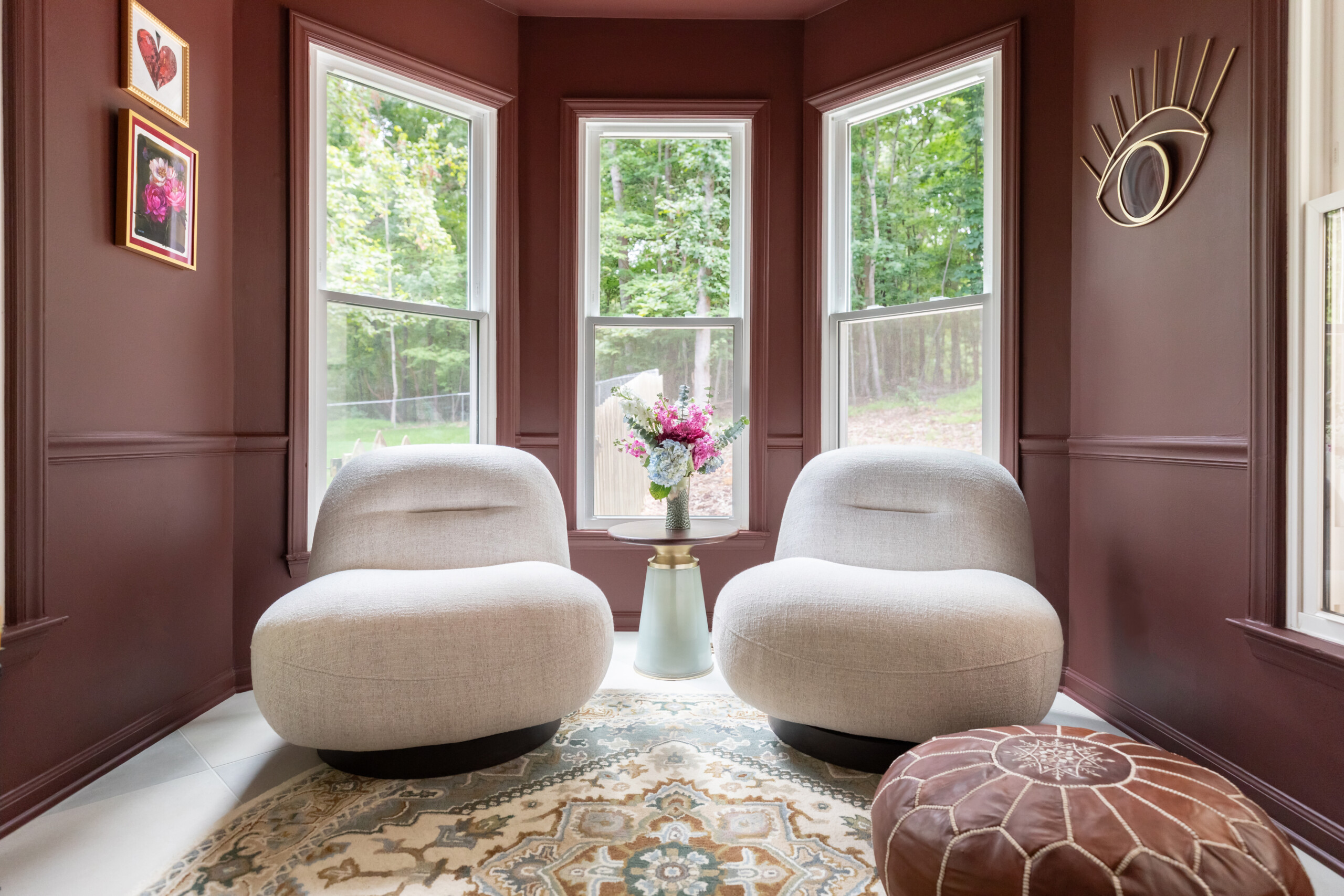 Breakfast nook turned cozy space featuring rich earthy clays to juxtapose the soft natural greens of the ktichen.