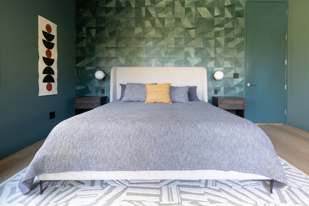 This modern, geometric bedroom combines dramatic greens with natural light for the perfect spot to unwind.