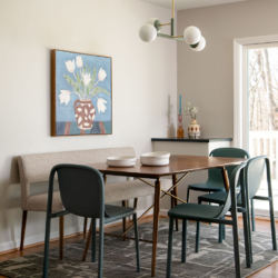Contemporary dining room with geometric rug, natural wall art, and accessories.