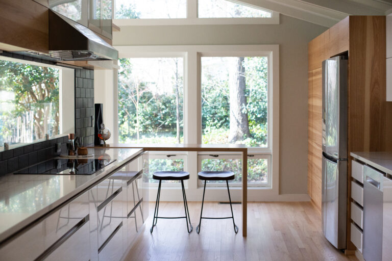 Galley kitchen with breakfast nook and picture window – TEW Studio Interior Designers Raleigh, NC