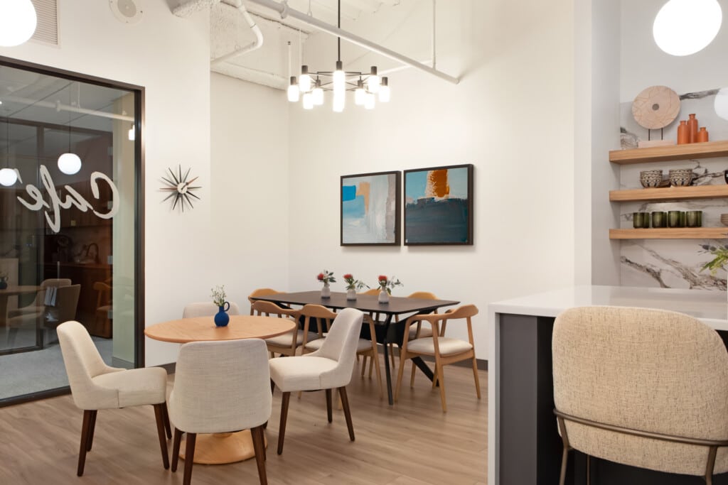 Various tables and seating options in workplace breakroom designed for employee wellness - TEW Design Studio