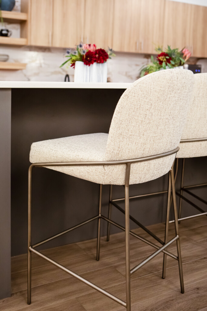 High-top chair with fabric seat and metal base in workplace breakroom designed for employee wellness - TEW Design Studio