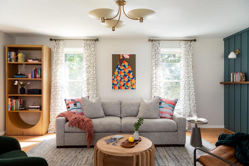 Neutral living room with pops of bold color, natural wood tones, and statement wall